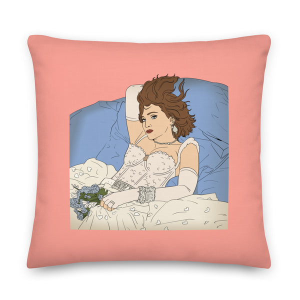 Pink square pillow with an illustration of Madonna reclining in bed with flowers