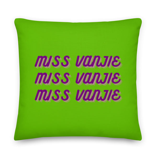 Front-facing bright green square pillow reading “MISS VANJIE” three times in purple script