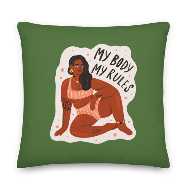 Front-facing green pillow reading “My Body My Rules,” with a seated illustrated woman