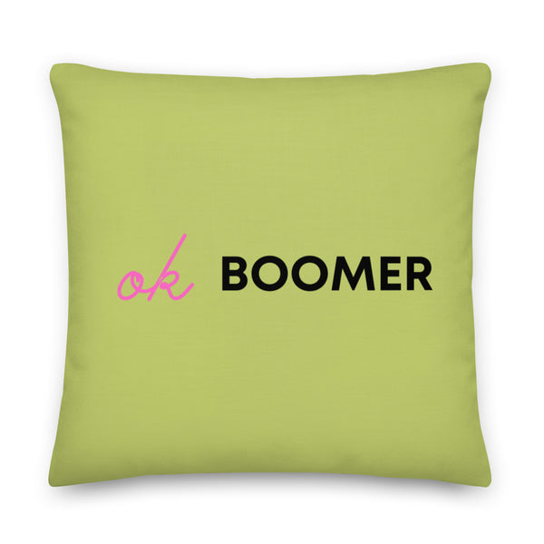 Square lime-green pillow reading “OK BOOMER” in pink script and black block letters