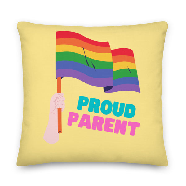 Yellow square pillow with a rainbow flag, raised fist, and “PROUD PARENT” text
