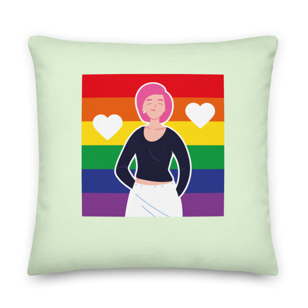 Light green square pillow with a cartoon person over rainbow stripes and two white hearts