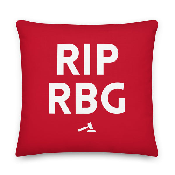 Red square pillow with large white “RIP RBG” text and a gavel icon