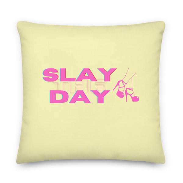 Pale yellow square pillow with pink “SLAY THE DAY” lettering and high-heel graphic