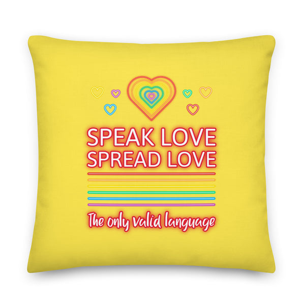 Yellow square pillow reading “SPEAK LOVE SPREAD LOVE” with rainbow hearts and stripes