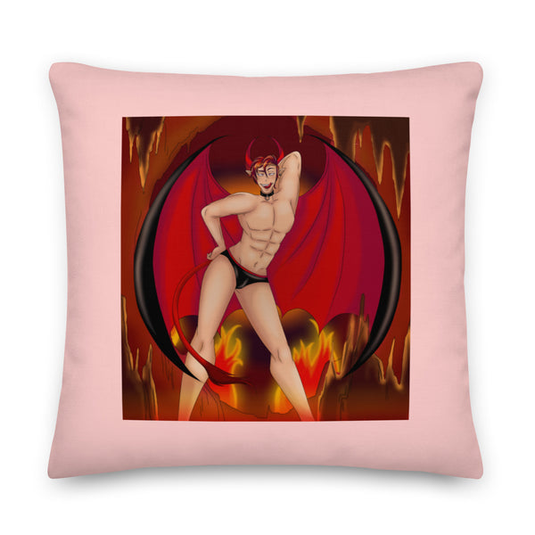 Front-facing pink pillow printed with a horned, winged demon in black briefs amid flames