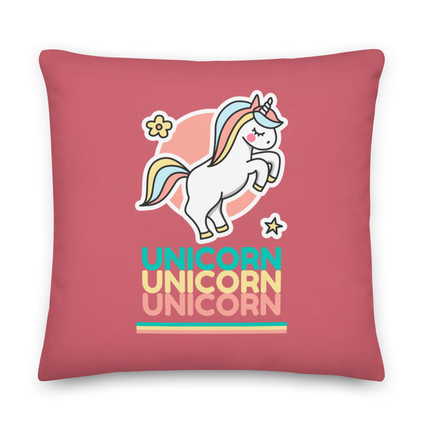 Square pink pillow with a cartoon unicorn and three stacked “UNICORN” words