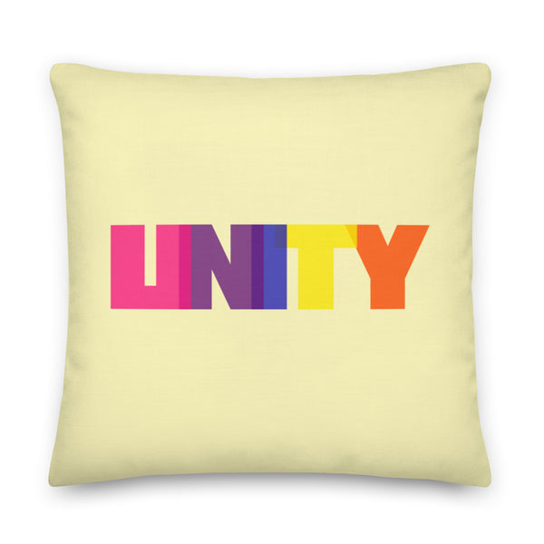 Pale yellow square pillow with large multicolored “UNITY” lettering on the front