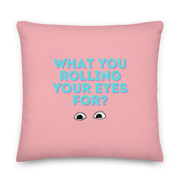 Front-facing pink square pillow reading “WHAT YOU ROLLING YOUR EYES FOR?” with cartoon eyes