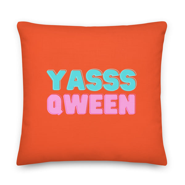 Front-facing orange square pillow with turquoise and pink “YASSS QWEEN” lettering