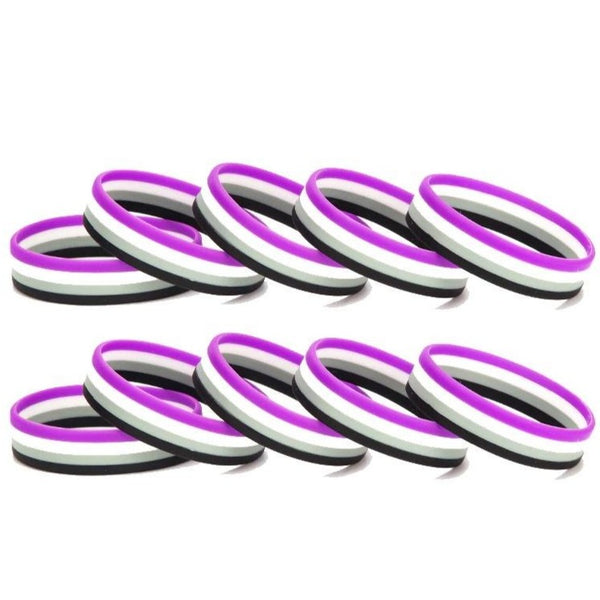 Ten purple, white, and black rubber wristbands arranged in two rows