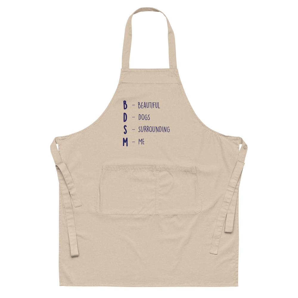 Front view of a beige apron with navy text reading “BDSM – Beautiful Dogs Surrounding Me”