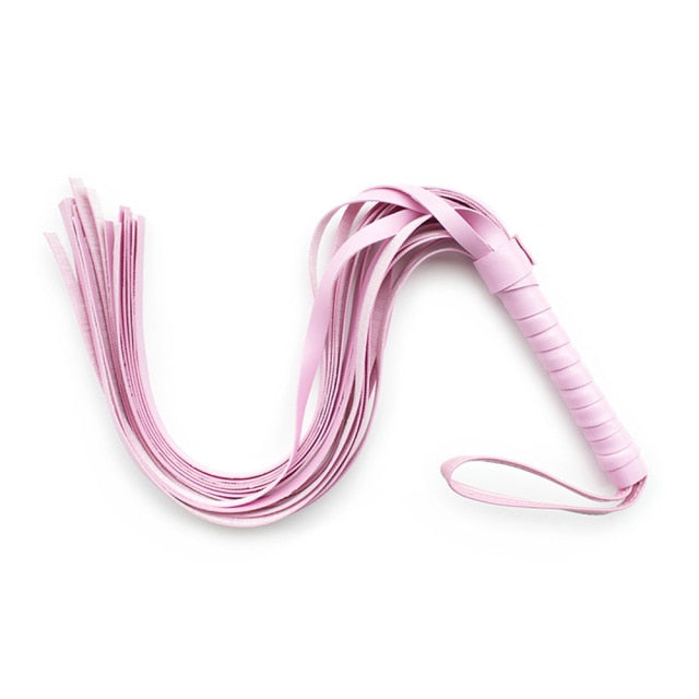 Close-up of a pink multi-tail BDSM fetish whip with wrapped handle and wrist loop