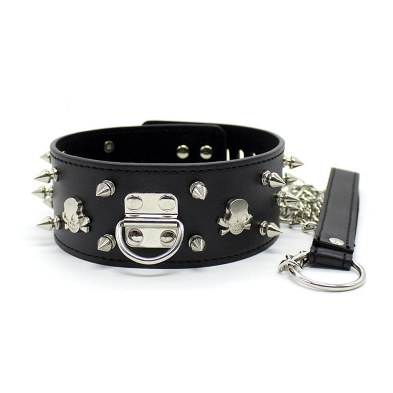 Black studded BDSM collar with skull accents, O-ring clasp, chain, and matching lead
