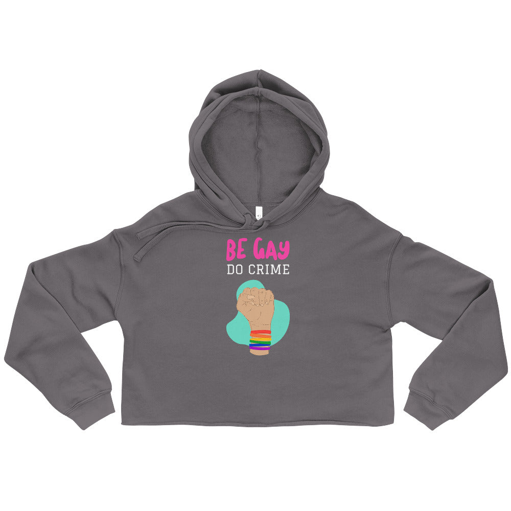 Front view of a charcoal cropped hoodie reading “BE GAY DO CRIME,” with a raised fist graphic