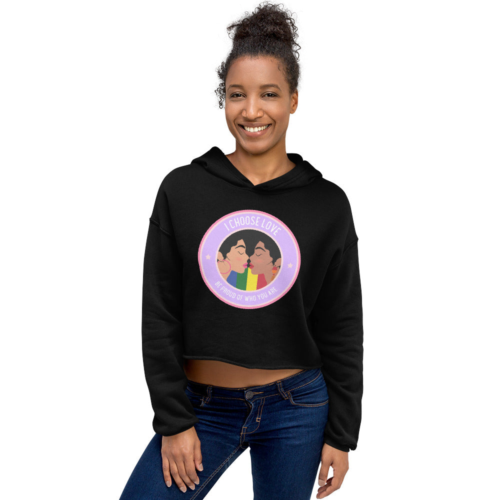 Front view of a smiling model wearing a black cropped hoodie with a colorful kissing-couple graphic