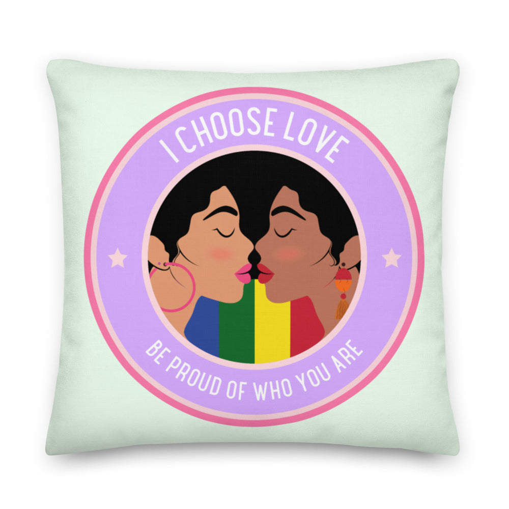 Mint-green square pillow with two women kissing, rainbow stripes, and circular text reading “I CHOOSE LOVE” and “BE PROUD...