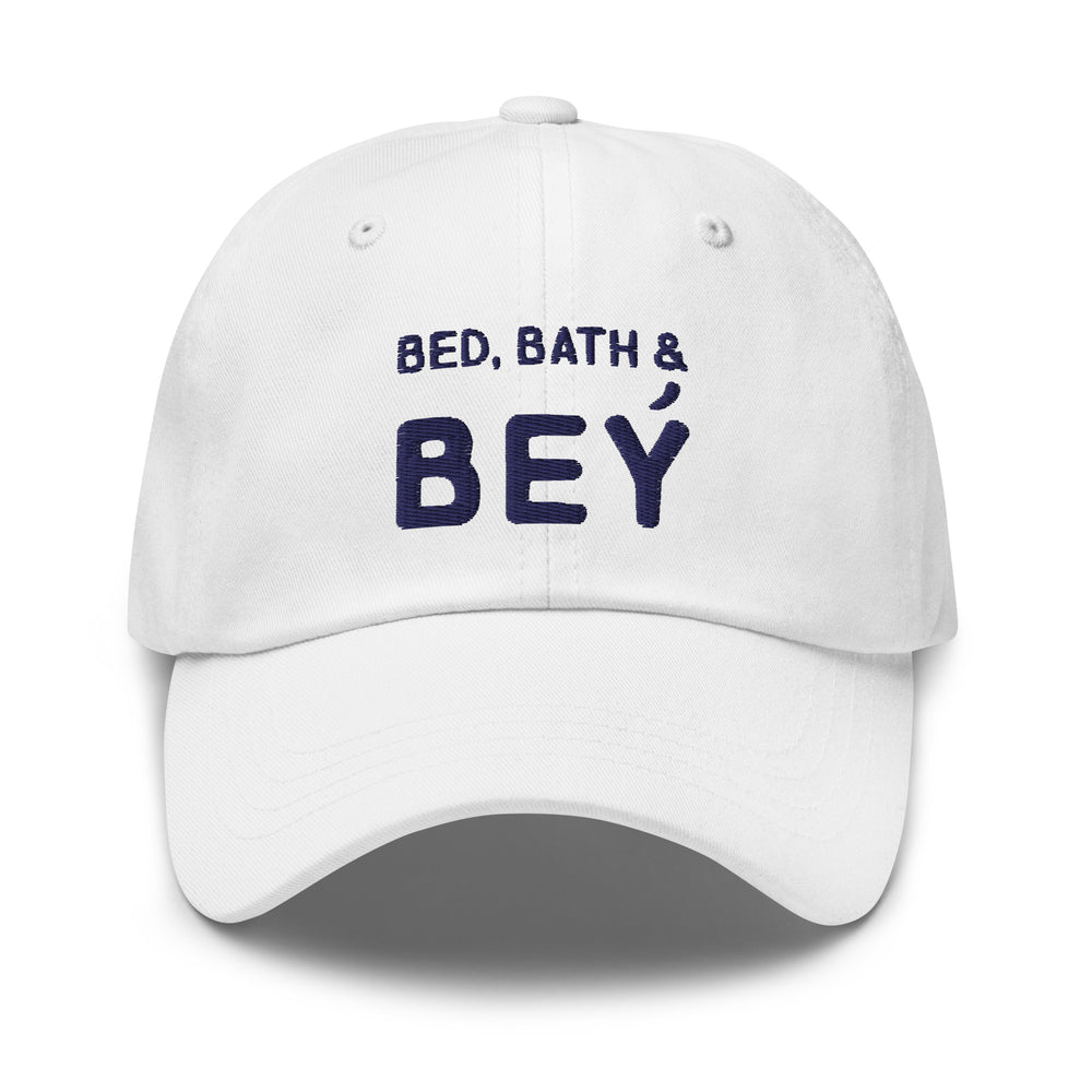 White baseball cap with navy “BED, BATH & BEY” lettering, shown from the front