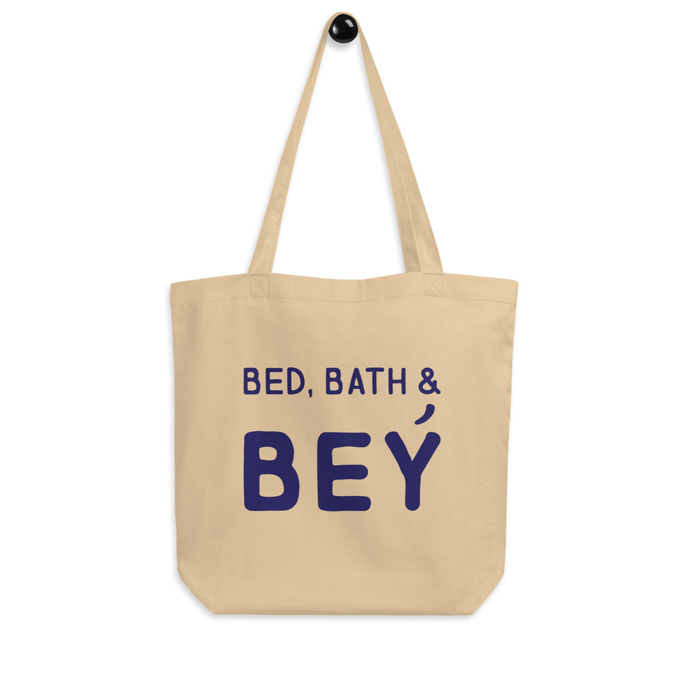 Front-facing beige tote bag reading “BED, BATH & BEY” in dark blue