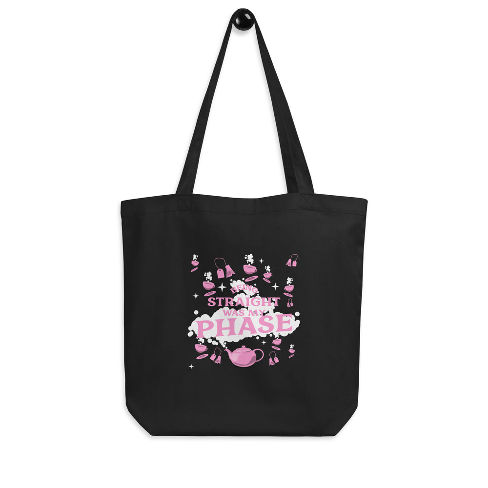 Front view of a black tote bag reading “BEING STRAIGHT WAS MY PHASE” in pink and white