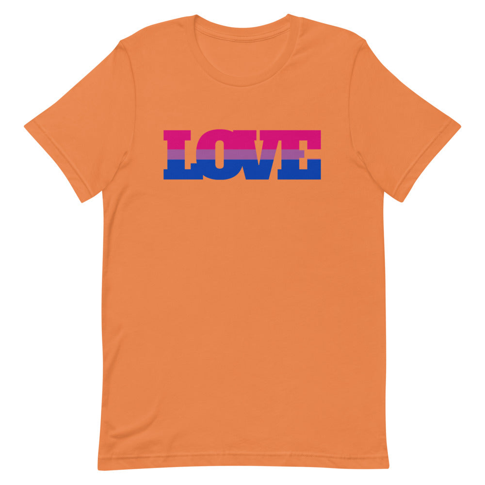 bi shirt: Folded Bisexual Love T-Shirt with “LOVE” in rainbow letters and queer pins on a striped blanket