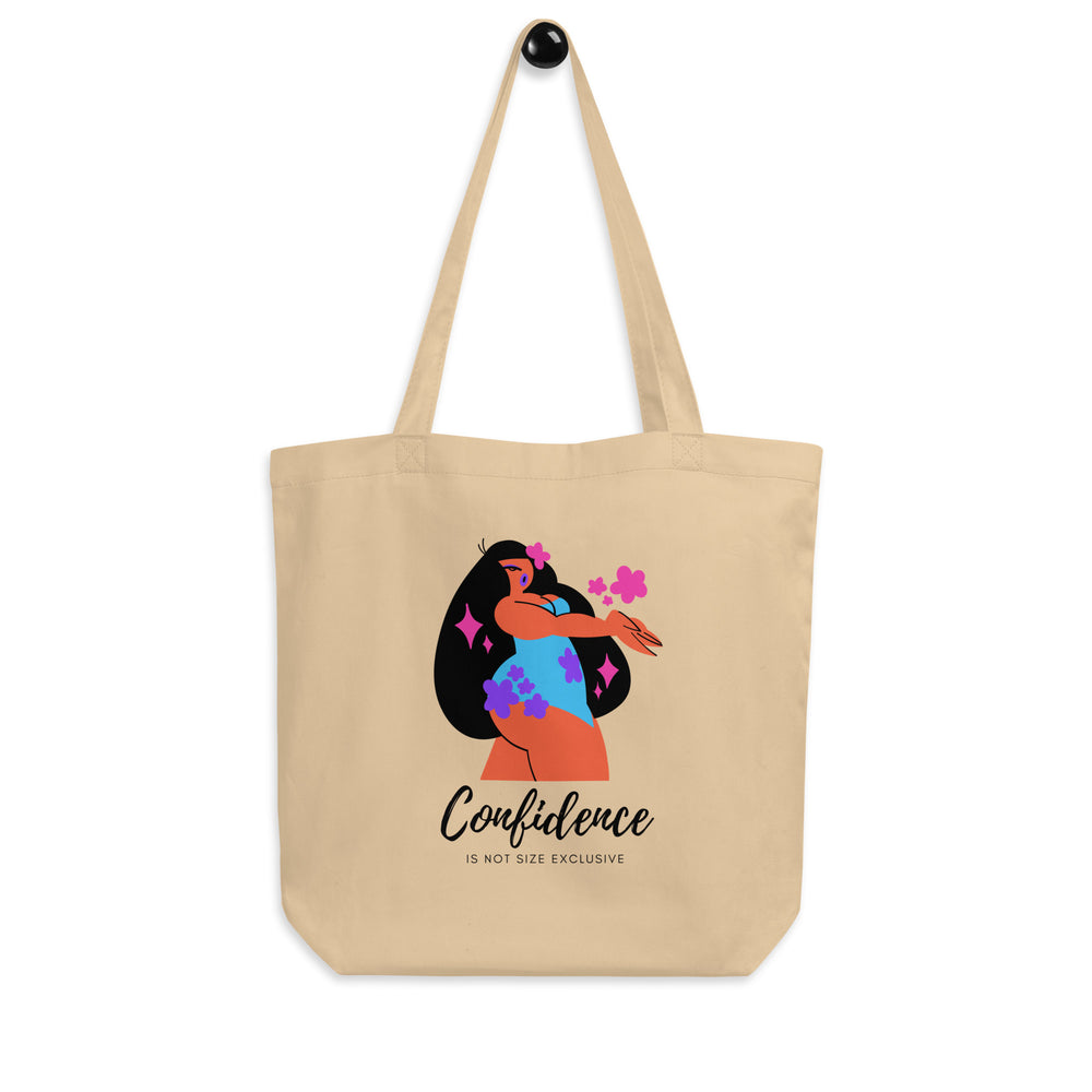 Beige tote bag with a colorful woman illustration and “Confidence Is Not Size Exclusive” text