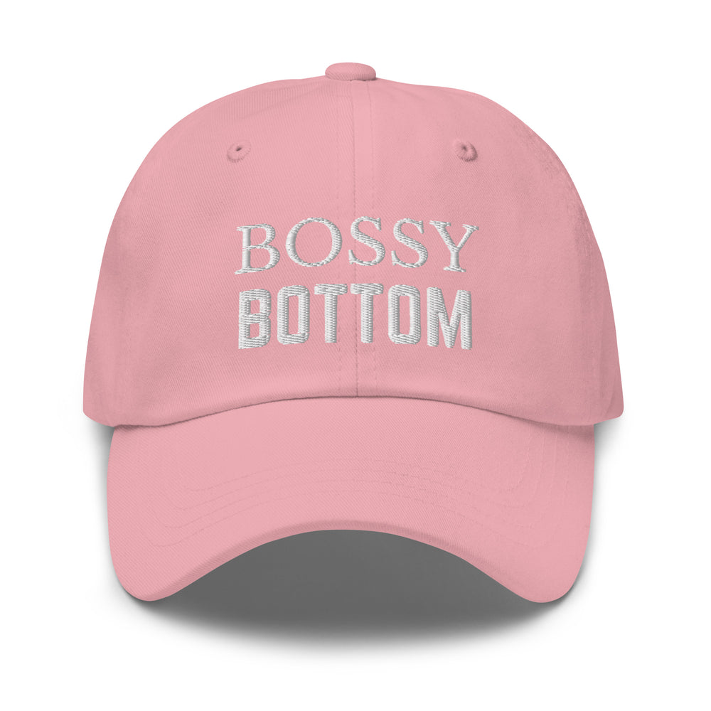 Front view of a pink baseball cap embroidered with “BOSSY BOTTOM” in silver lettering