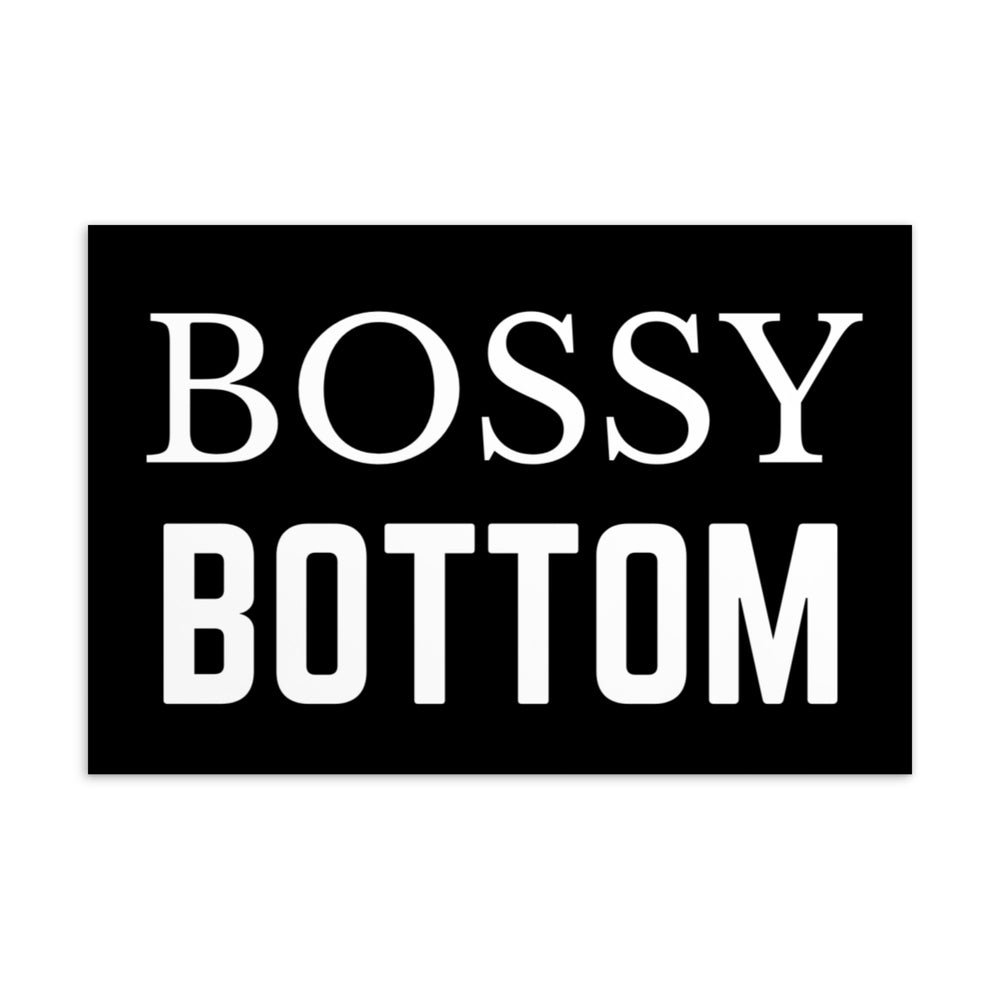Black postcard with large white text reading “BOSSY BOTTOM.”