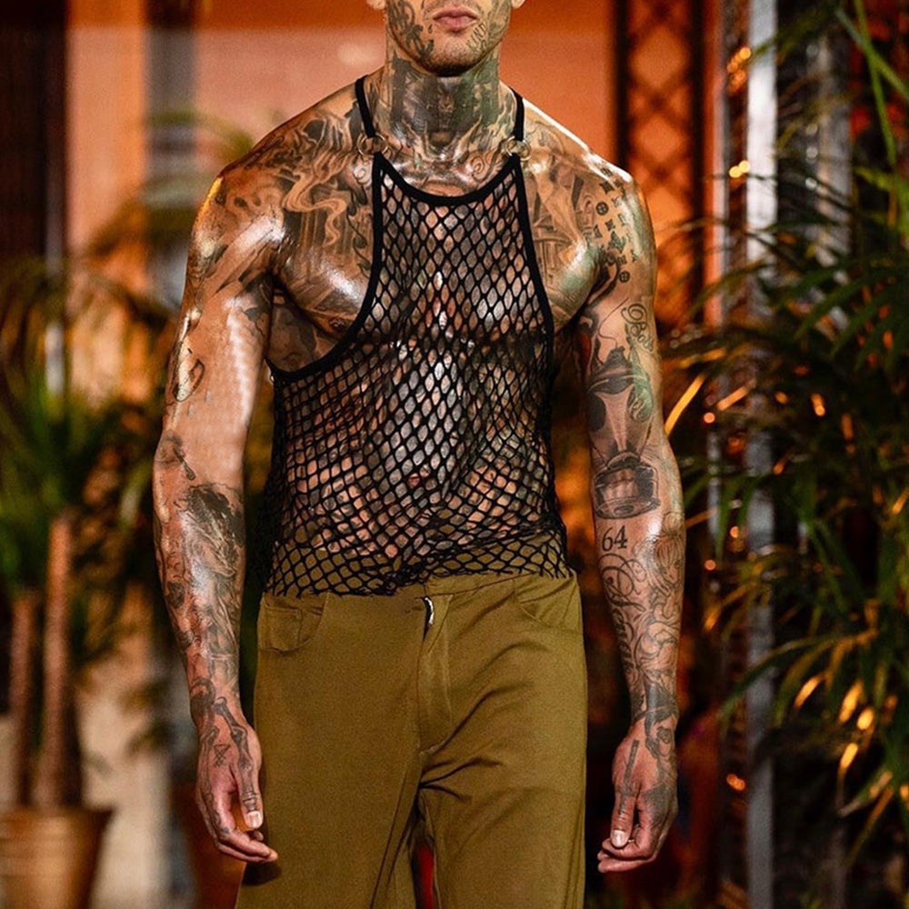 Front view of a tattooed model wearing a black fishnet tank top over bare skin