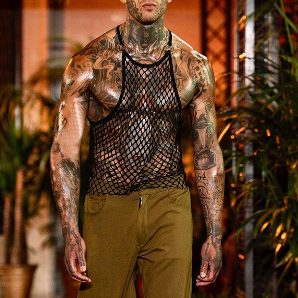 Front view of a tattooed model wearing a black fishnet tank top over bare skin