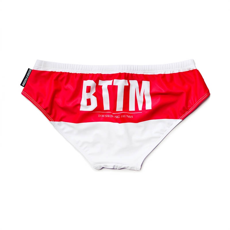 Red and white swim briefs with large white BTTM lettering