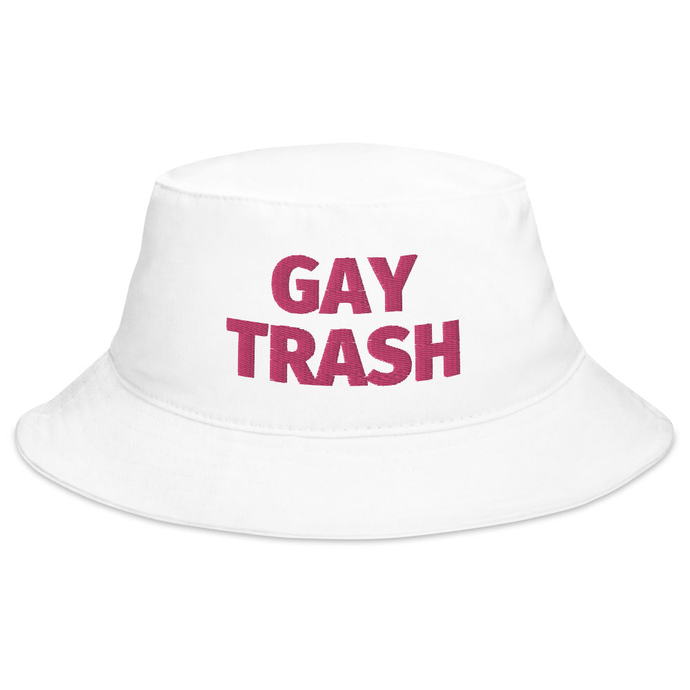 White bucket hat with magenta “GAY TRASH” lettering on the front