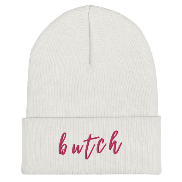 White ribbed cuffed beanie with the word “butch” embroidered in pink on the front