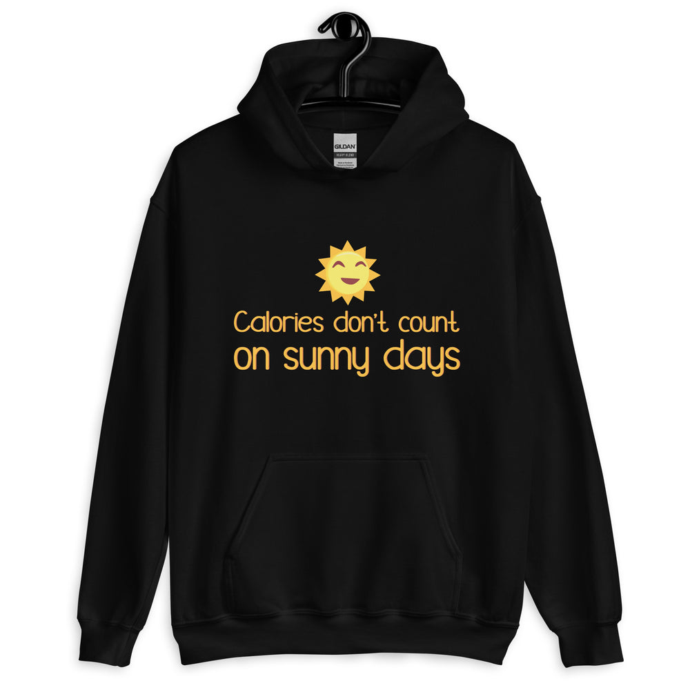 Front view of a black hoodie with a smiling sun and “Calories don’t count on sunny days” text