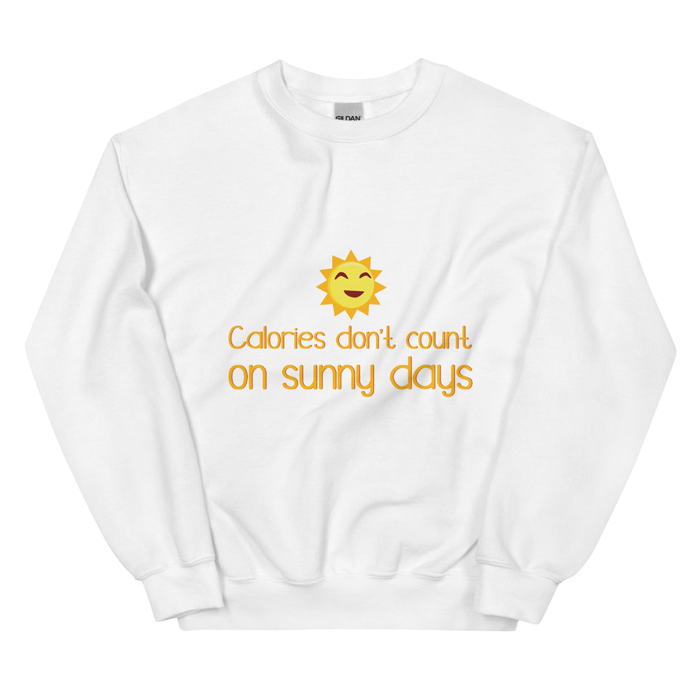 Front view of a white sweatshirt with a smiling sun and “Calories don’t count on sunny days”