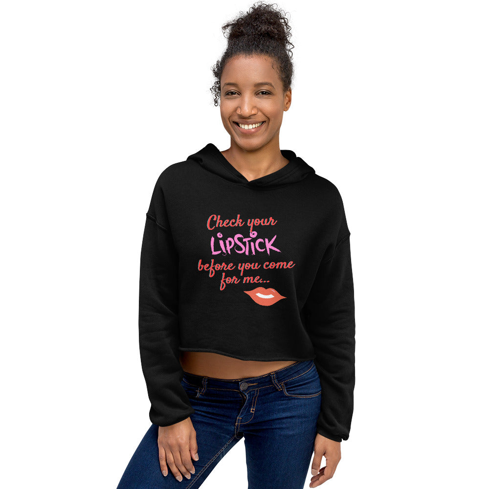 Model wearing a black cropped hoodie reading “Check your lipstick before you come for me...”