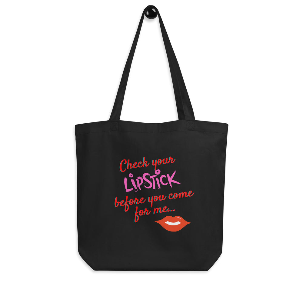Black tote bag reading “Check your lipstick before you come for me...” with red lips