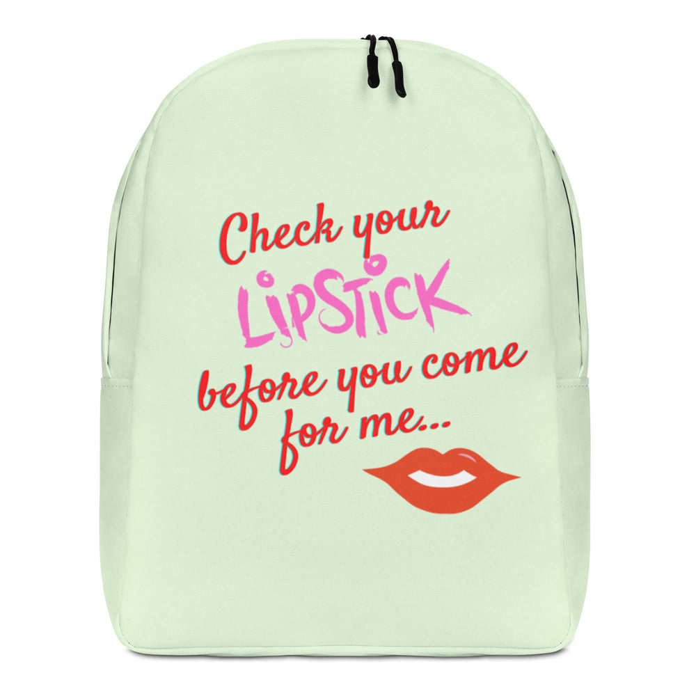 Front-facing pale green backpack reading “Check your LIPSTICK before you come for me...” with red lips