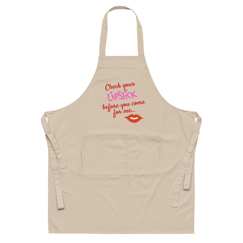 Front view of a beige apron with colorful “Check your Lipstick before you come for me...” text and lips