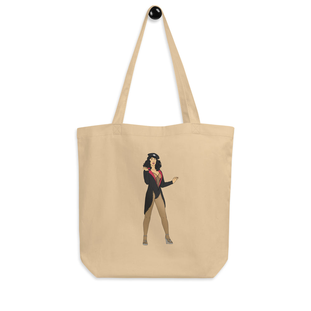 Front view of a beige tote bag featuring an illustrated burlesque performer in black attire