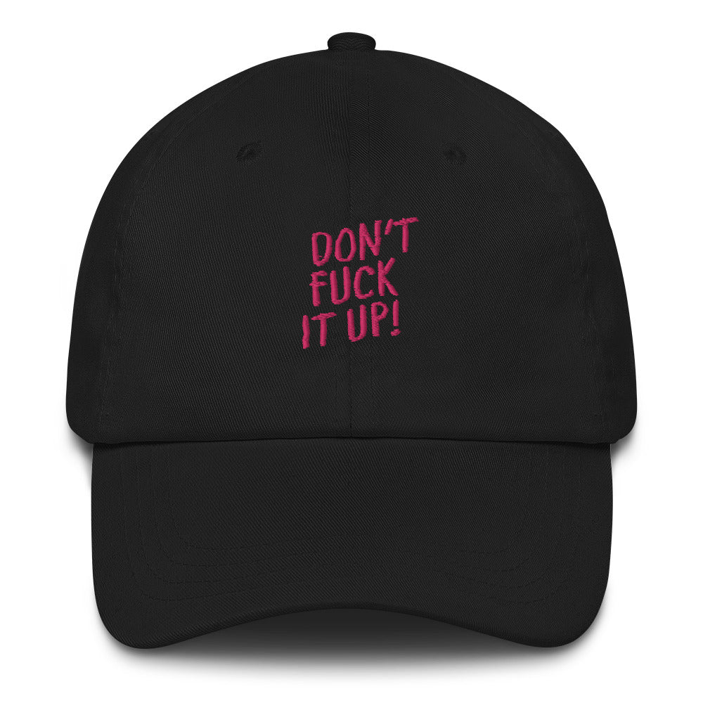 Front view of a black baseball cap with pink “DON’T FUCK IT UP!” lettering