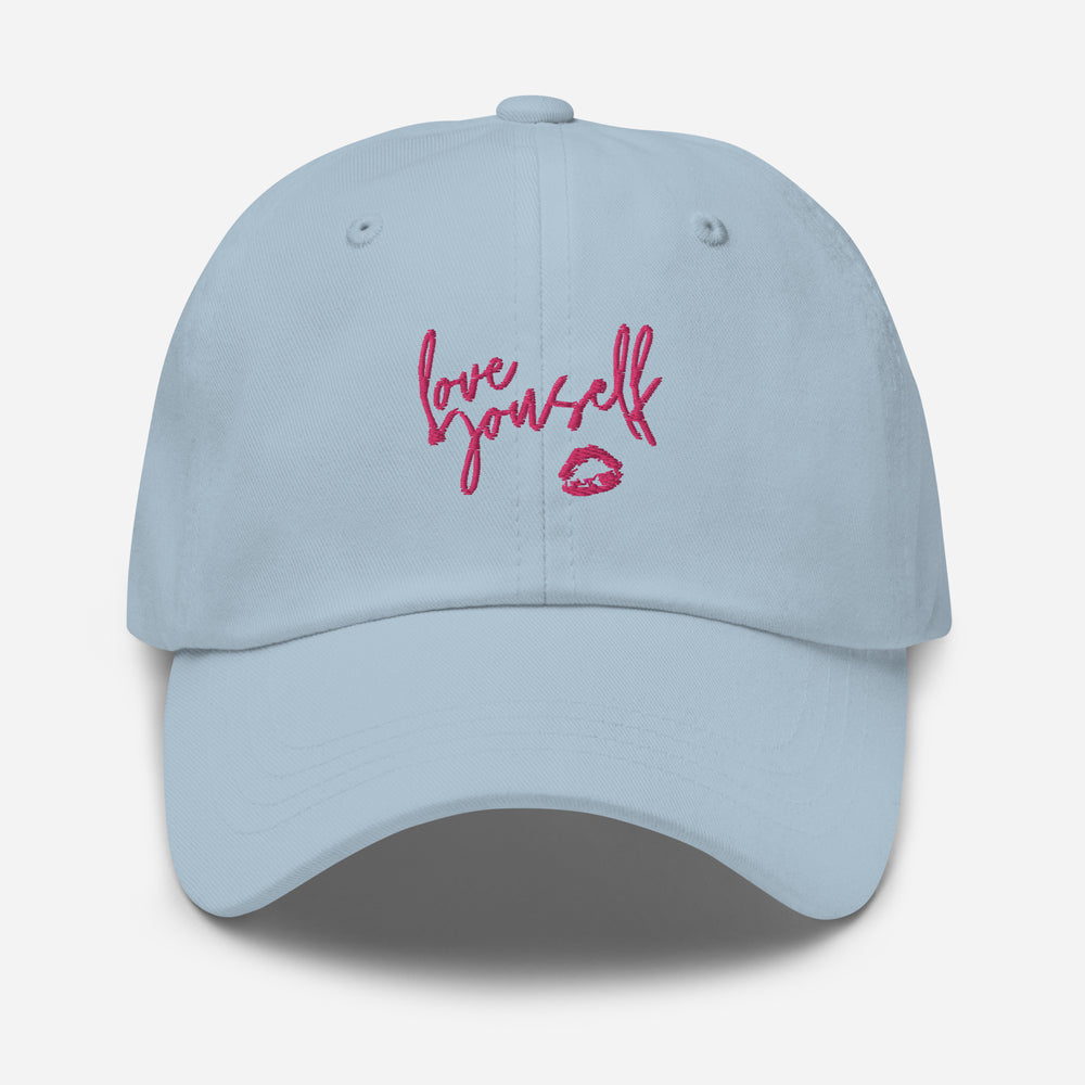 Front view of a light blue cap embroidered with “Love yourself” and a pink lips graphic.