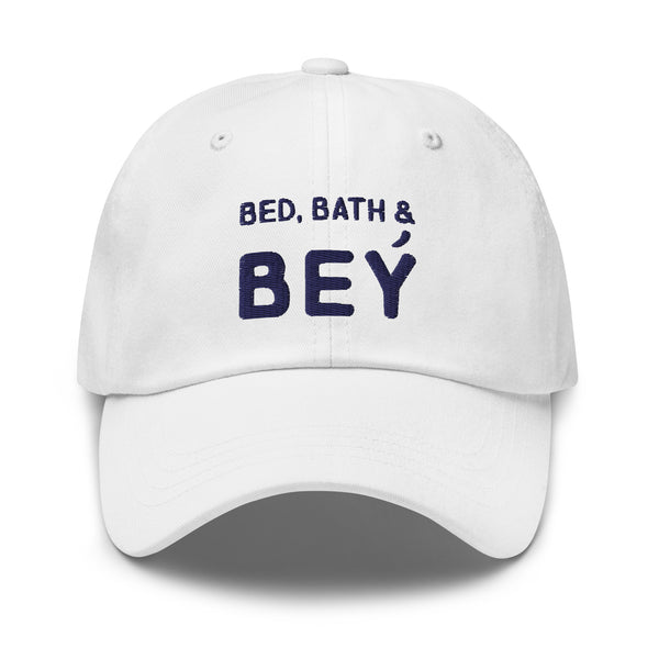 White baseball cap with navy “BED, BATH & BEY” lettering, shown from the front