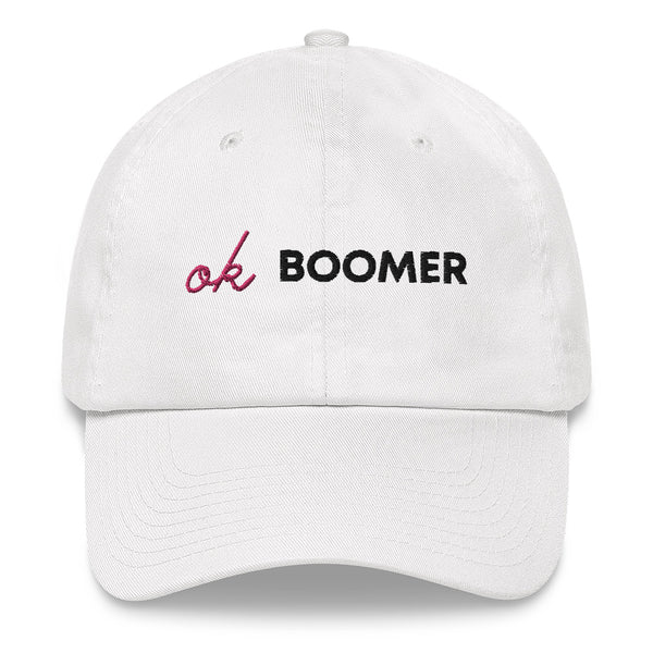 Front-facing white baseball cap embroidered with pink and black “Ok Boomer” text