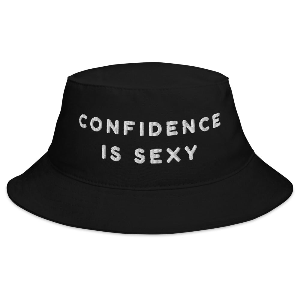 Black bucket hat with white embroidered text reading “CONFIDENCE IS SEXY”