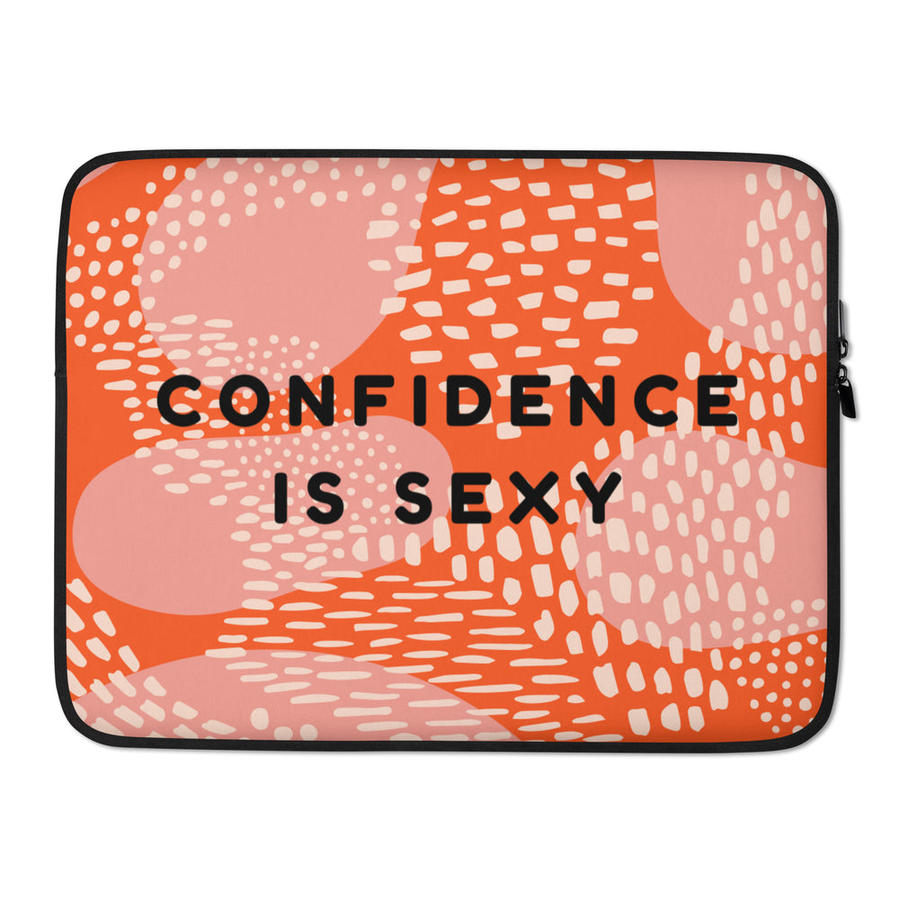 Front view of an orange and pink laptop sleeve reading “CONFIDENCE IS SEXY”