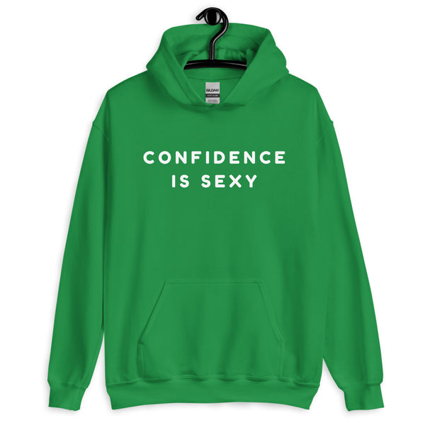 Front view of a green pullover hoodie on a hanger reading “CONFIDENCE IS SEXY”