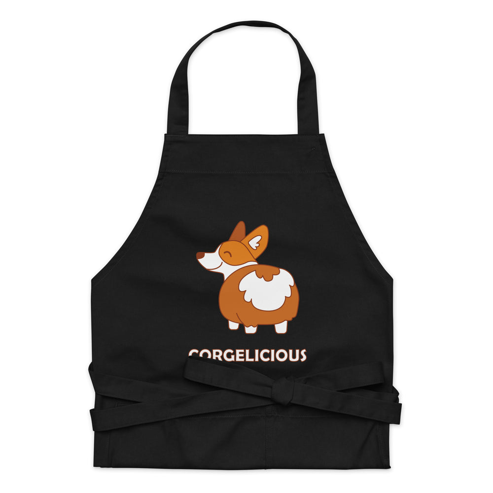 Black apron with a cartoon corgi and “CORGELICIOUS” lettering, shown front-facing