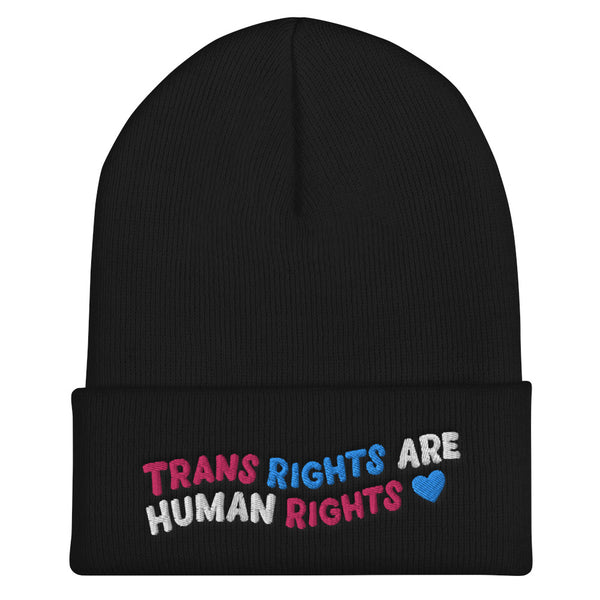Front view of a black cuffed beanie reading “TRANS RIGHTS ARE HUMAN RIGHTS” with a blue heart