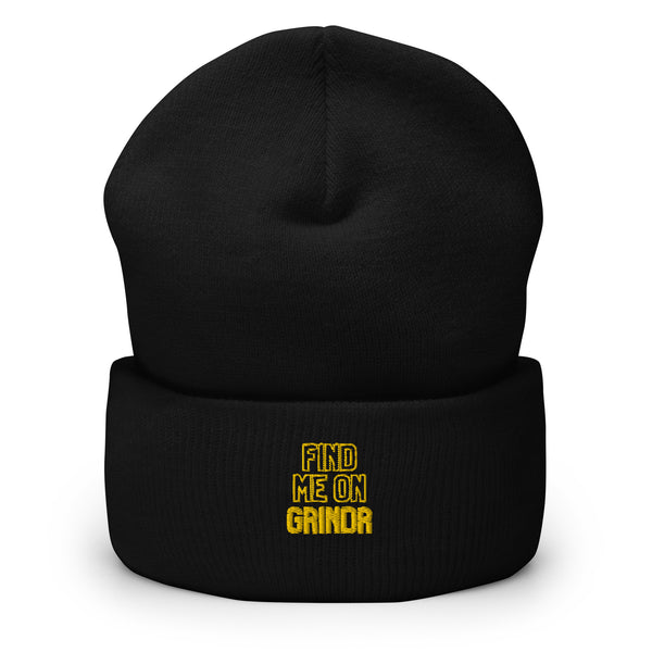 Front view of a black cuffed beanie embroidered in yellow with “FIND ME ON GRINDR”